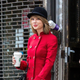 Taylor Swift in red coat with a Starbucks coffee